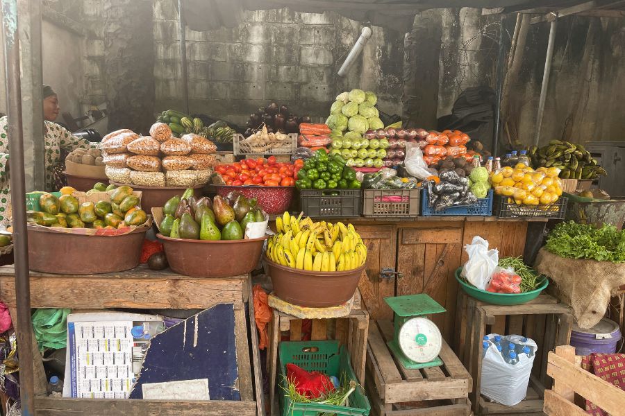 A simple outdoor fruit and vegetable stand in the Zone 4 neighborhood of Abidjan, Côte d'Ivoire.