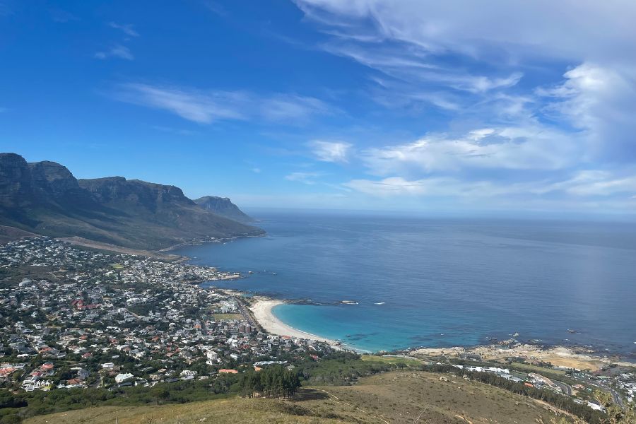 A panoramic view of beaches and ocean from the top of Lion's Head, a hike which should be on every Cape Town itinerary.