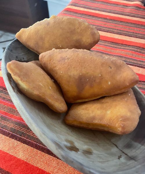 Puffy brown fried pastries, Mandazi, are an iconic Mombasa street food