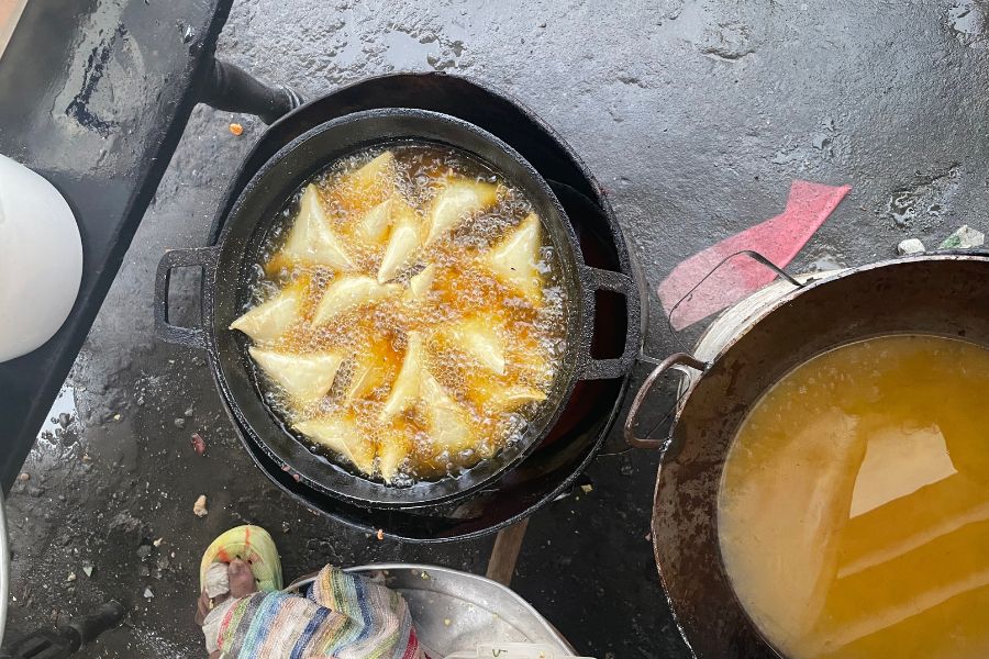 Samosas, a popular Mombasa street food, fry in boiling oil.