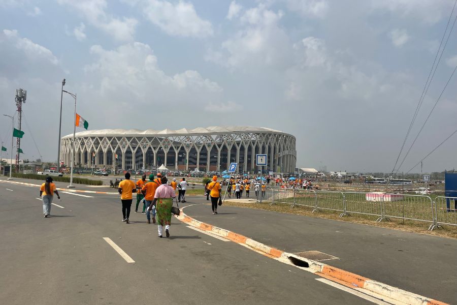 Orange-clad spectators walk to the Ebimpé stadium in Abidjan, Ivory Coast for the final match of AFCON 2024