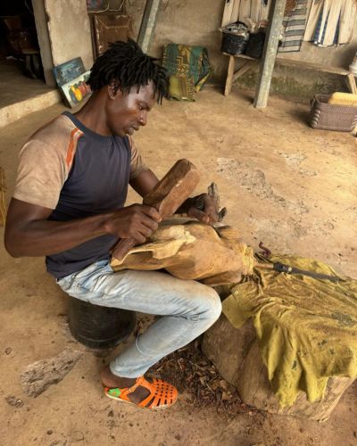 A woodcarver hard at work in Man, Côte d'Ivoire