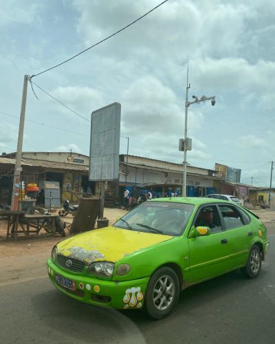 A bright green taxi in Man, Côte d'Ivoire, home to the Dent de Man hike.